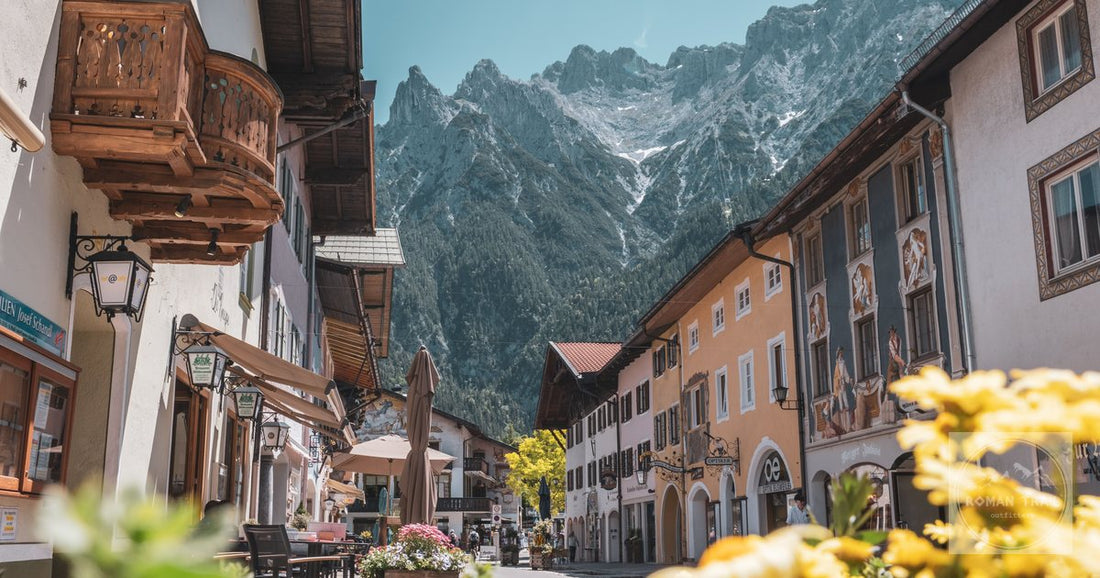 Picturesque street in Mittenwald, Germany showcasing traditional Bavarian architecture with impressive mountain backdrop.