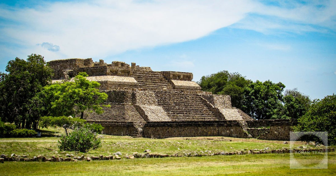 Explore the ancient Monte Albán Pyramid in Oaxaca under a clear blue sky.