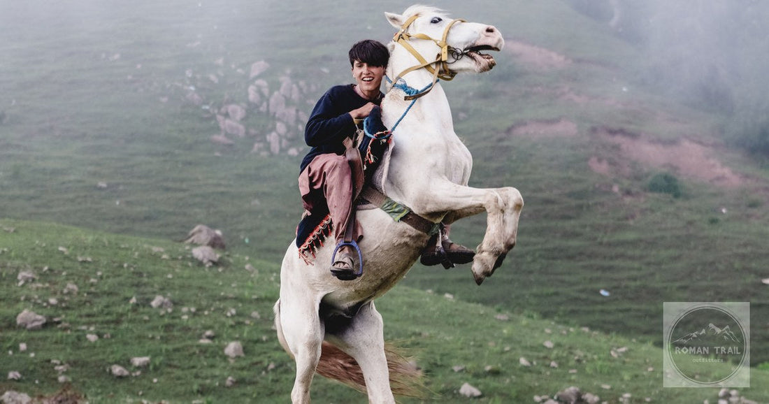 A rider on a rearing horse in the misty hills at Naran, Pakistan