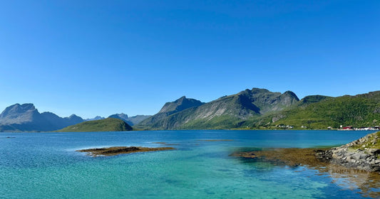 Turquoise water below mountains in Nordland, Norway