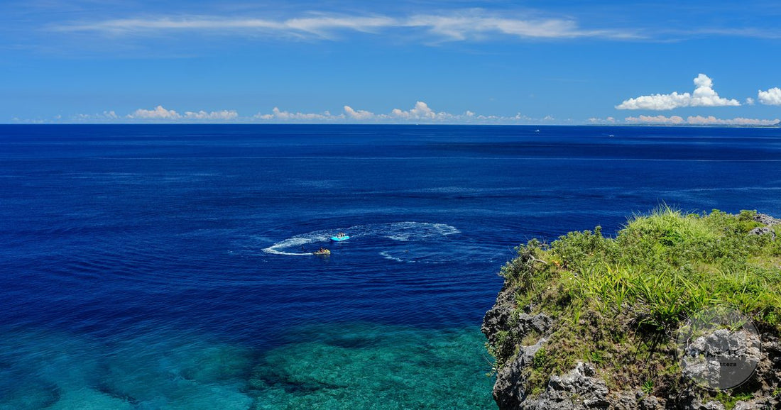 Clear turquoise water below a limestone cliff on the Okinawa coast, Okinawa packing list for women by Roman Trail Outfitters