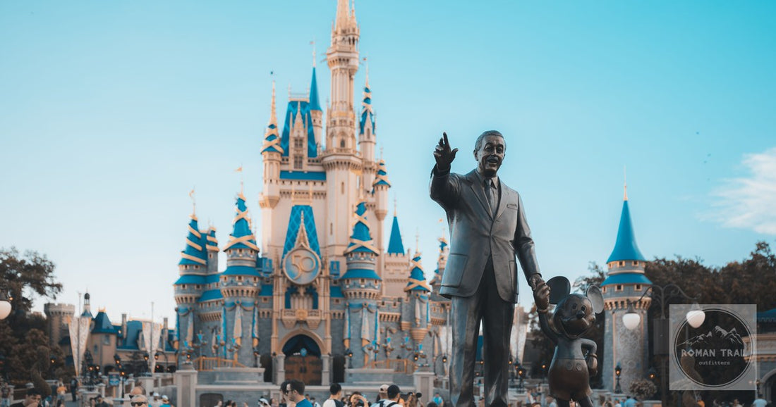View of the iconic Cinderella Castle at Walt Disney World in Orlando, Florida, with crowd and statue.