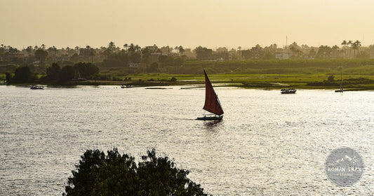 Traditional felucca sailboat on the Nile River at sunset in Luxor, Egypt women's packing list destination