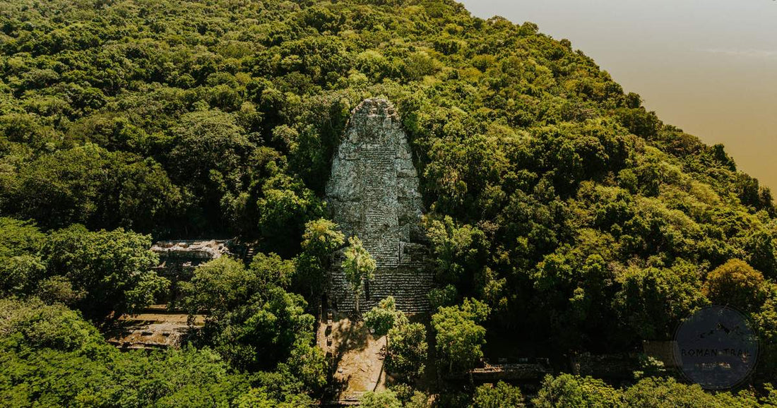 Mayan pyramid temple rising above the jungle canopy at Tikal, Guatemala, women's packing list by Roman Trail Outfitters