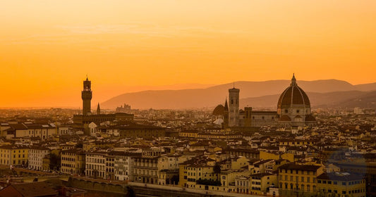 Florence skyline with the Duomo silhouetted against a warm orange sunset - Roman Trail Outfitters Italy packing list