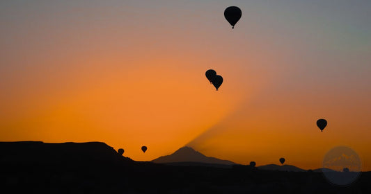 Silhouetted hot air balloons over Cappadocia at sunrise, women's Turkey packing list by Roman Trail Outfitters
