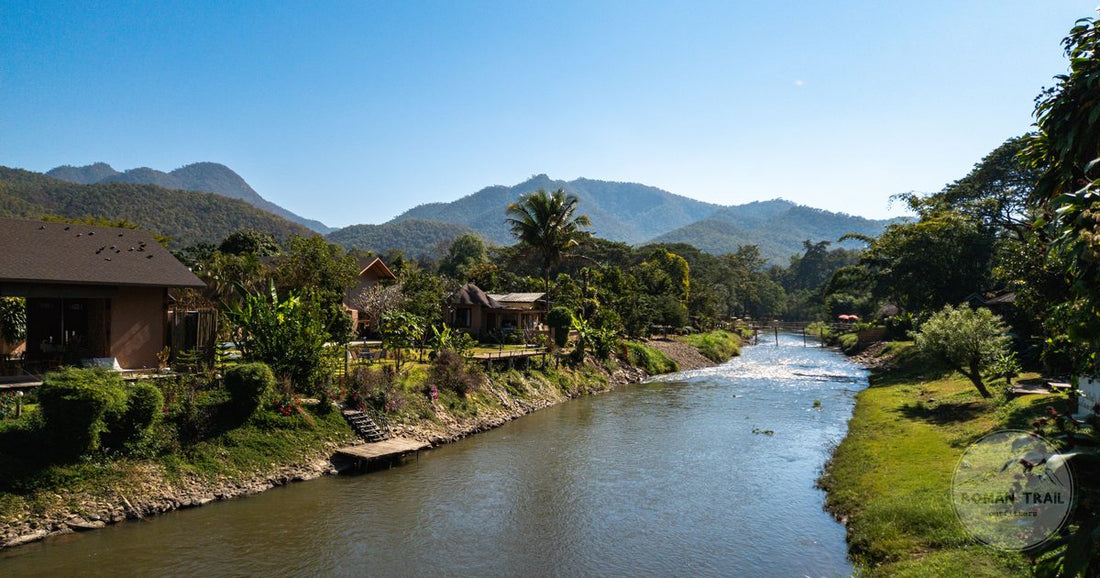 A riverside village among forested mountains in northern Thailand
