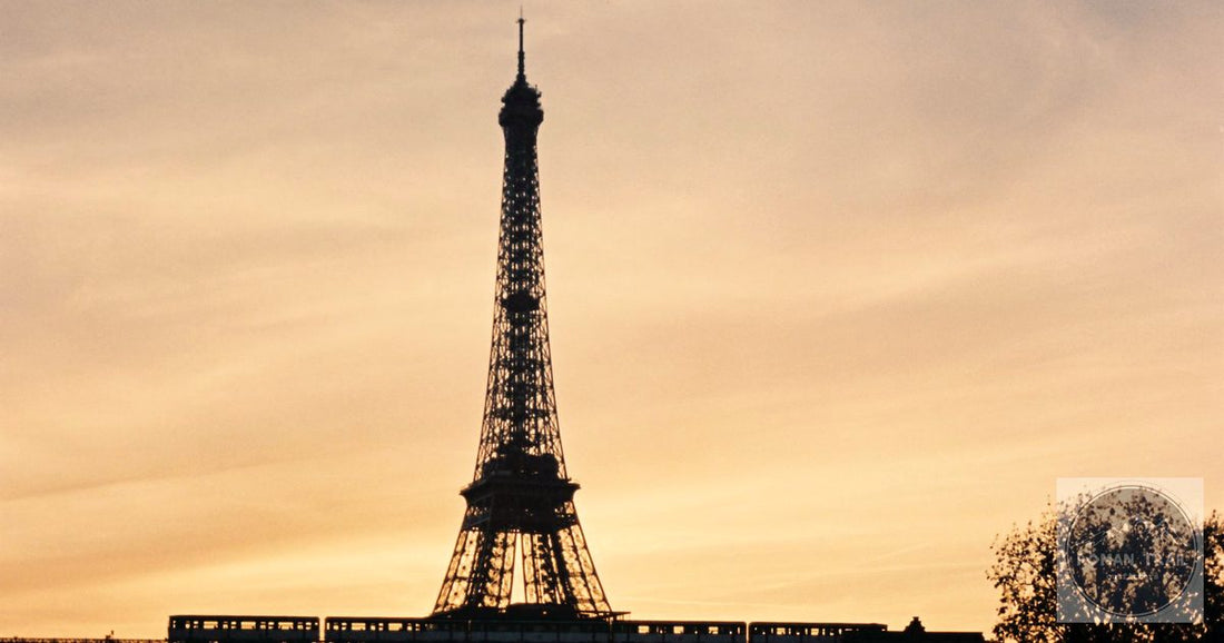 Eiffel Tower silhouette over the Seine at golden hour sunset, Paris packing list for women by Roman Trail Outfitters