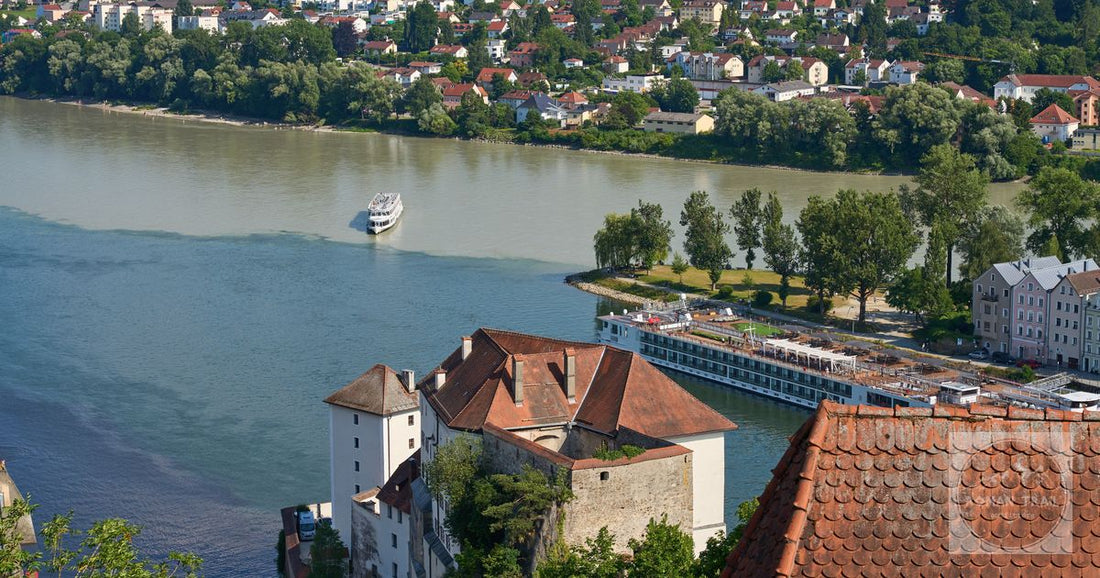 Stunning aerial view of the confluence of three rivers in Passau, Germany, with historic architecture and lush greenery.