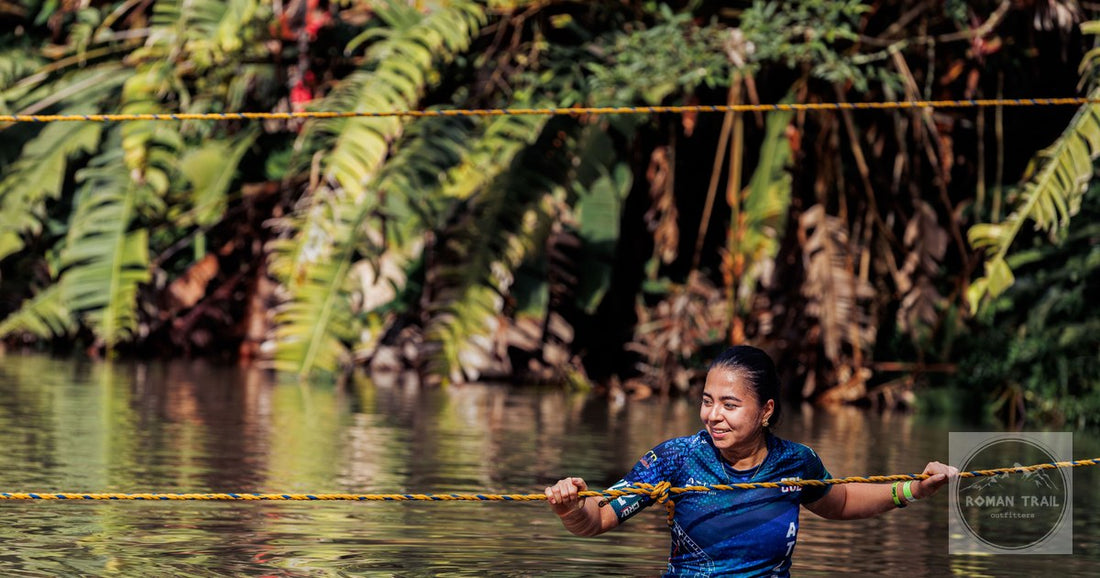 A woman crossing a river in the jungle of Risaralda, Colombia