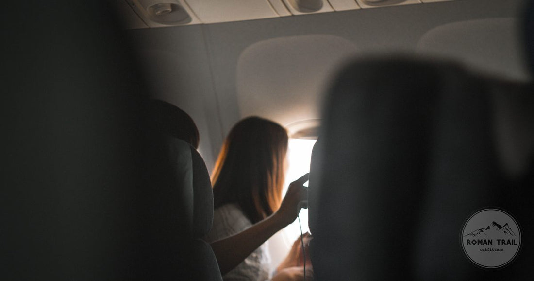 A woman looking out of an aircraft window in flight