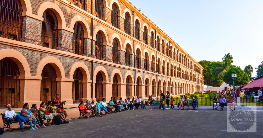 People gathered outside the historic Cellular Jail with its distinctive arched windows and barred archit