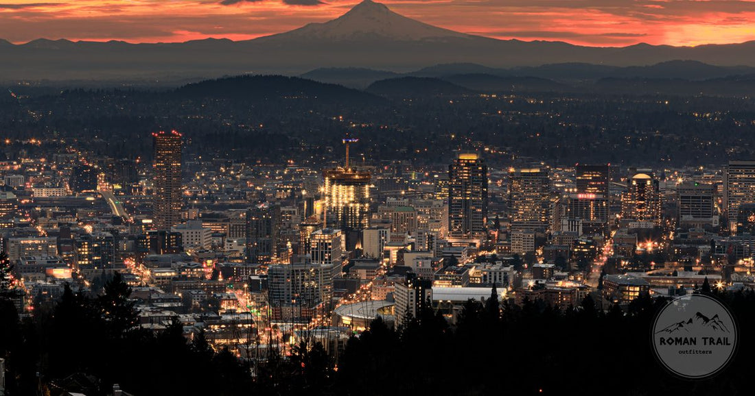 Downtown Portland lit at dusk with Mount Hood silhouetted against an orange sunset, Portland packing list for women by Roman Trail Outfitters