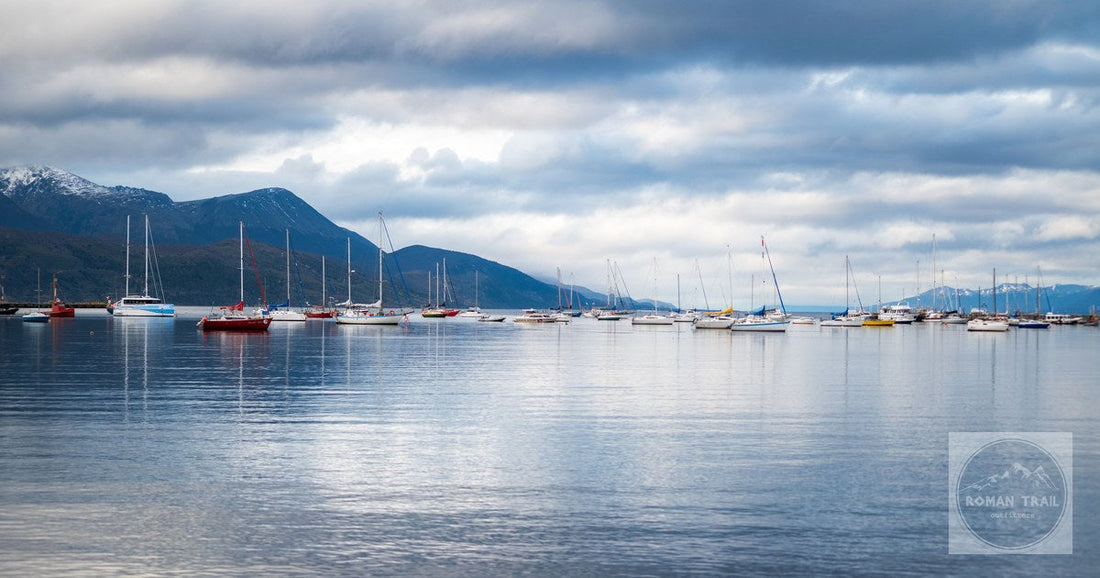 Sailboats anchored in the Beagle Channel below mountains