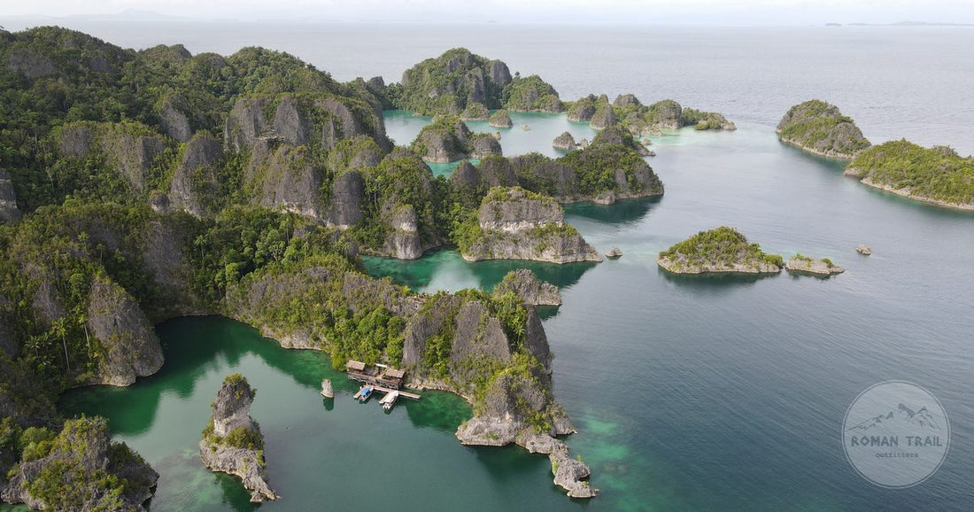 Aerial view of the karst islands and turquoise water of Raja Ampat, Raja Ampat packing list for women by Roman Trail Outfitters