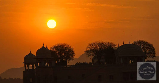 Jal Mahal palace silhouette against a warm orange sunset in Jaipur Rajasthan India, featured image for a Rajasthan packing list for women