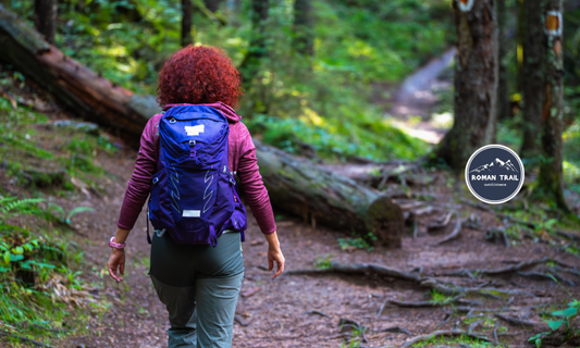 Woman hiking on a snowy, windy ridge in winter wearing proper layers