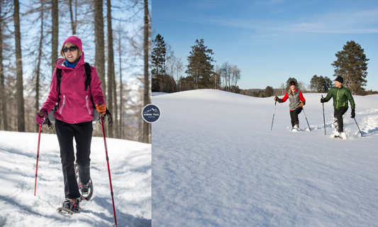 Woman snowshoeing through a snowy forest wearing layered winter hiking clothing