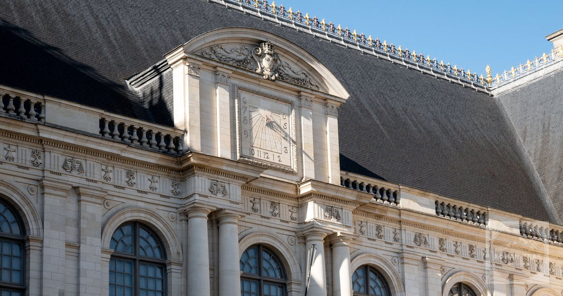Close-up of a historic building facade with a sundial in Rennes, Brittany, France.