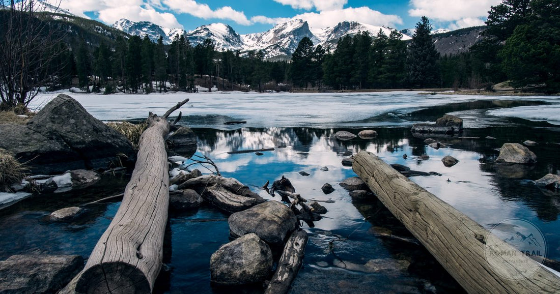 Snow covered mountains above an icy lake at Estes Park, Colorado