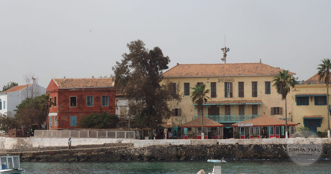 A coastal townscape of colourful historic buildings along a waterfront
