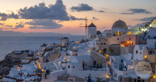 Sunset over the white buildings of Oia, Santorini, Greece