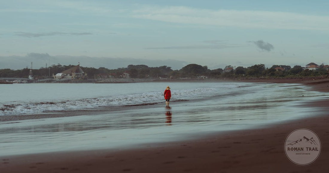 A lone walker on Sanur Beach at dawn, Bali, Indonesia