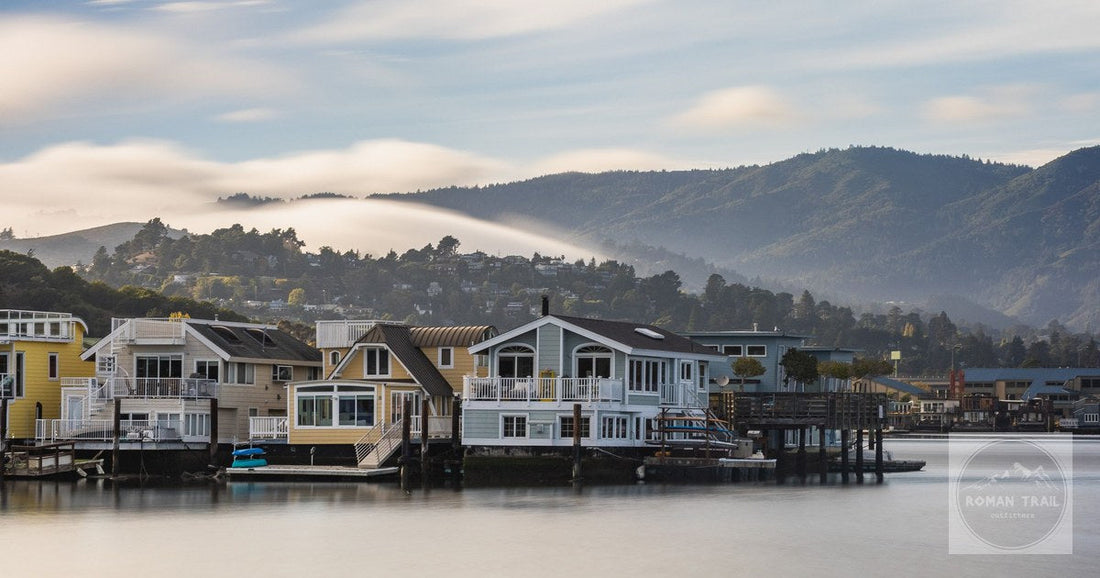 Charming houseboats in Sausalito with a serene mountain backdrop during sunrise.