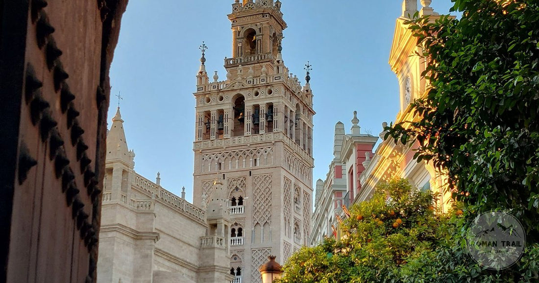 La Giralda tower framed by an archway at sunset, Seville packing list for women by Roman Trail Outfitters