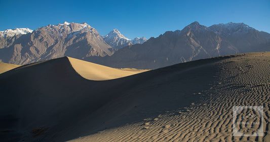 The Katpana cold desert dunes against snow-capped mountains at Skardu, Pakistan