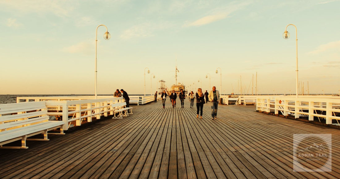 People walking the long wooden pier at Sopot, Poland, at sunset
