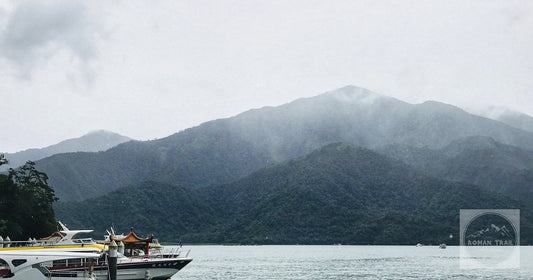 Boats moored at Sun Moon Lake with mist on the hills behind them, in the Nantou highlands of central Taiwan.