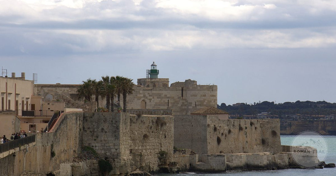 Limestone walls and the lighthouse on Ortigia island, Siracusa, Sicily