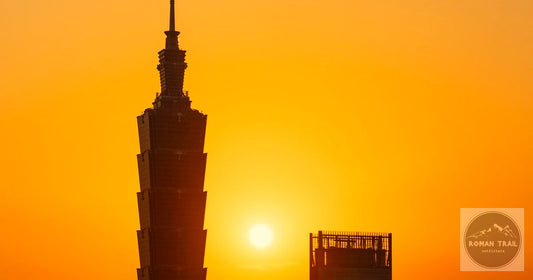 Silhouette of Taipei 101 tower against a warm orange sunset in Taiwan, featured image for a Taipei packing list for women