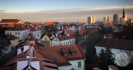 Red-tiled rooftops of Tallinn Old Town at golden hour, Tallinn packing list for women by Roman Trail Outfitters