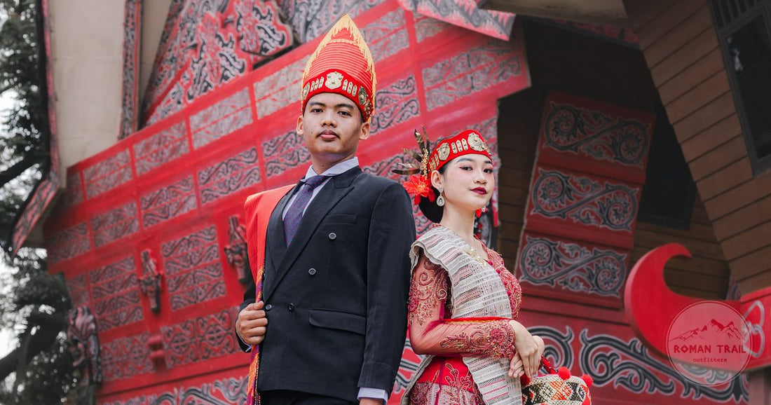 A couple in traditional dress in front of a Torajan house, Indonesia