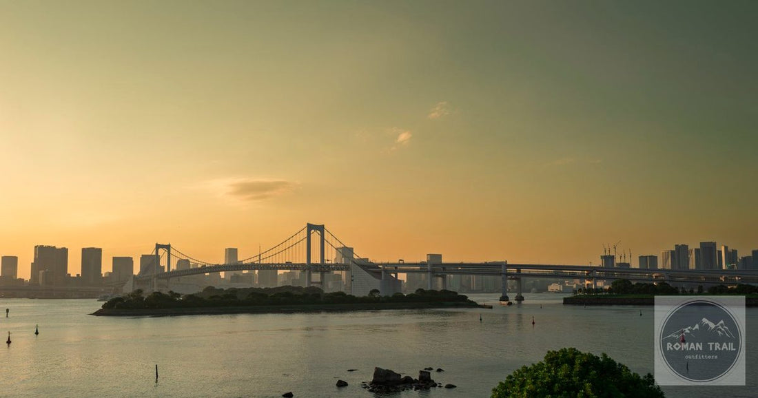 Rainbow Bridge and Tokyo Bay skyline at golden hour sunset, Tokyo packing list for women by Roman Trail Outfitters