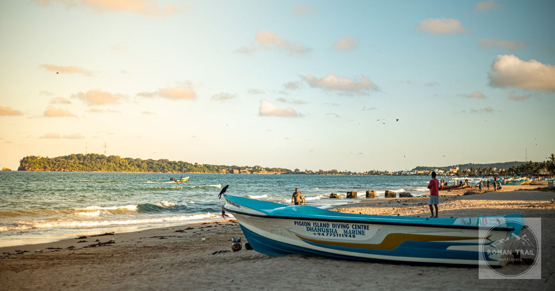 Fishing boats and people on the beach at Trincomalee, Sri Lanka