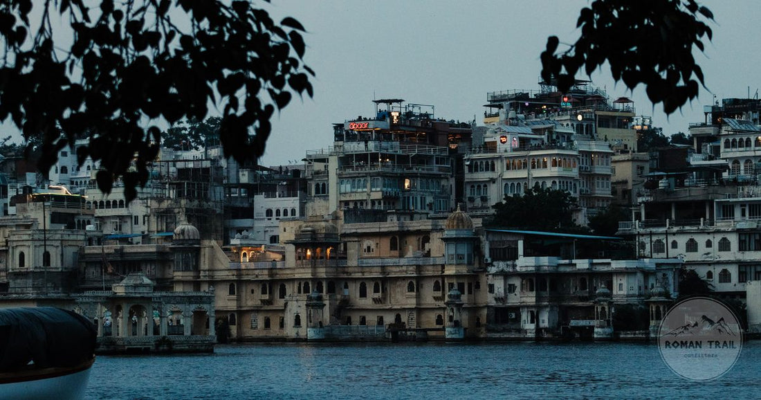 Udaipur City Palace seen from Lake Pichola at dusk, Rajasthan, India