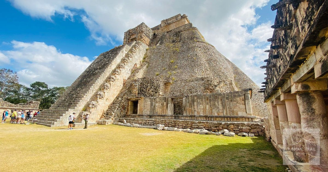 A striking view of the Pyramid of the Magician in Uxmal, Mexico, with tourists exploring the ancient May