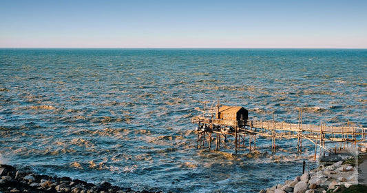 A tranquil view of a traditional trabocco fishing hut on the Adriatic Sea in Vasto, Abruzzo, Italy.