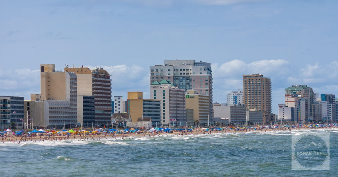 Crowds on the Virginia Beach boardwalk on a summer day, with the oceanfront hotel line behind them.