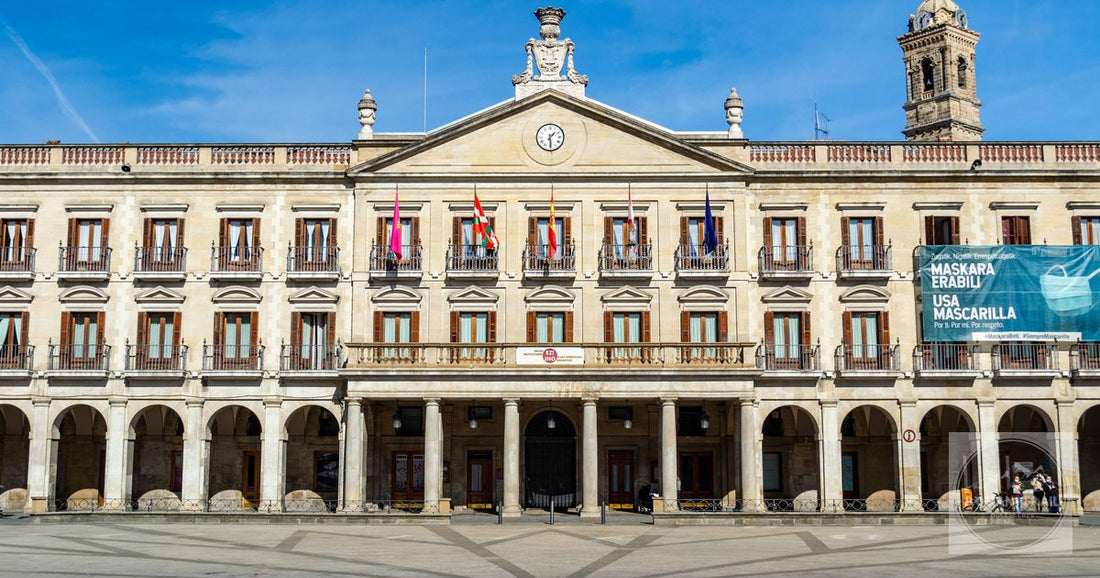 Front view of the historic facade of Vitoria-Gasteiz City Hall, Spain, with a clear blue sky.