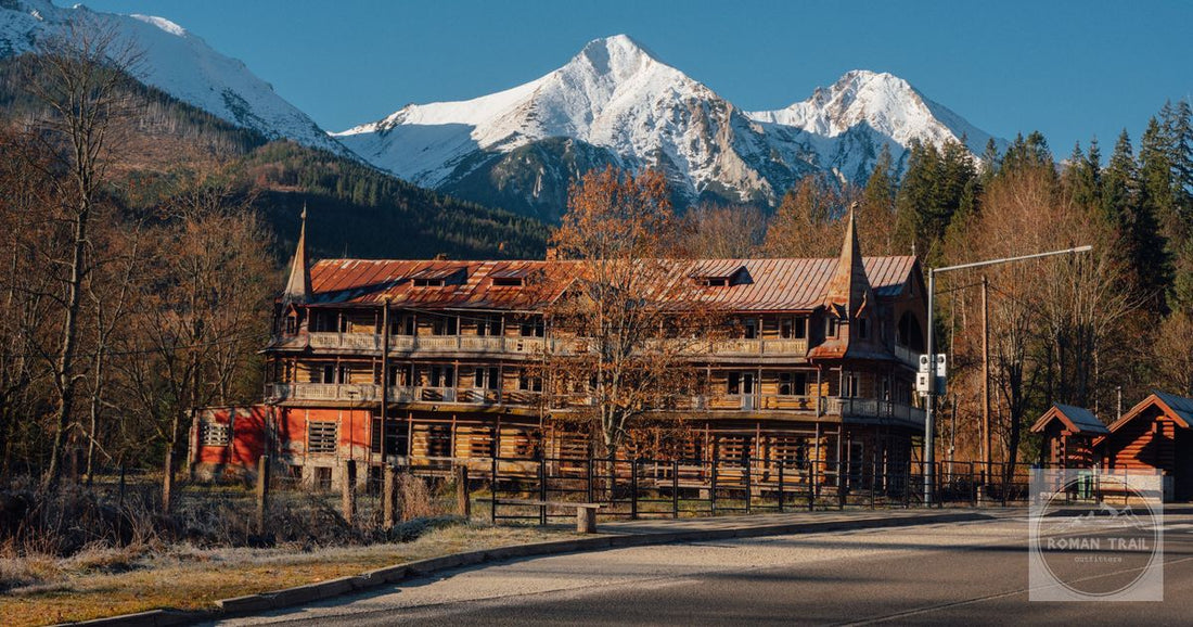 A historical wooden building against snow-capped mountains in Zdiar, Slovakia