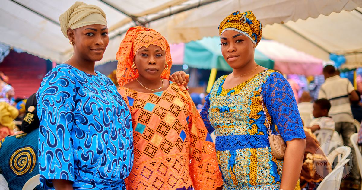 Three women in traditional dress at a cultural event in Abidjan, Ivory Coast