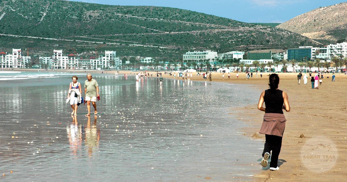 The wide sandy beach at Agadir on a sunny day, Agadir packing list for women by Roman Trail Outfitters