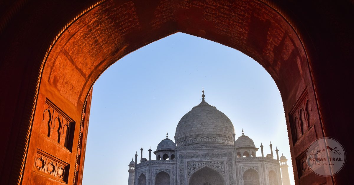 The Taj Mahal framed by an ornate gateway arch, Agra, India