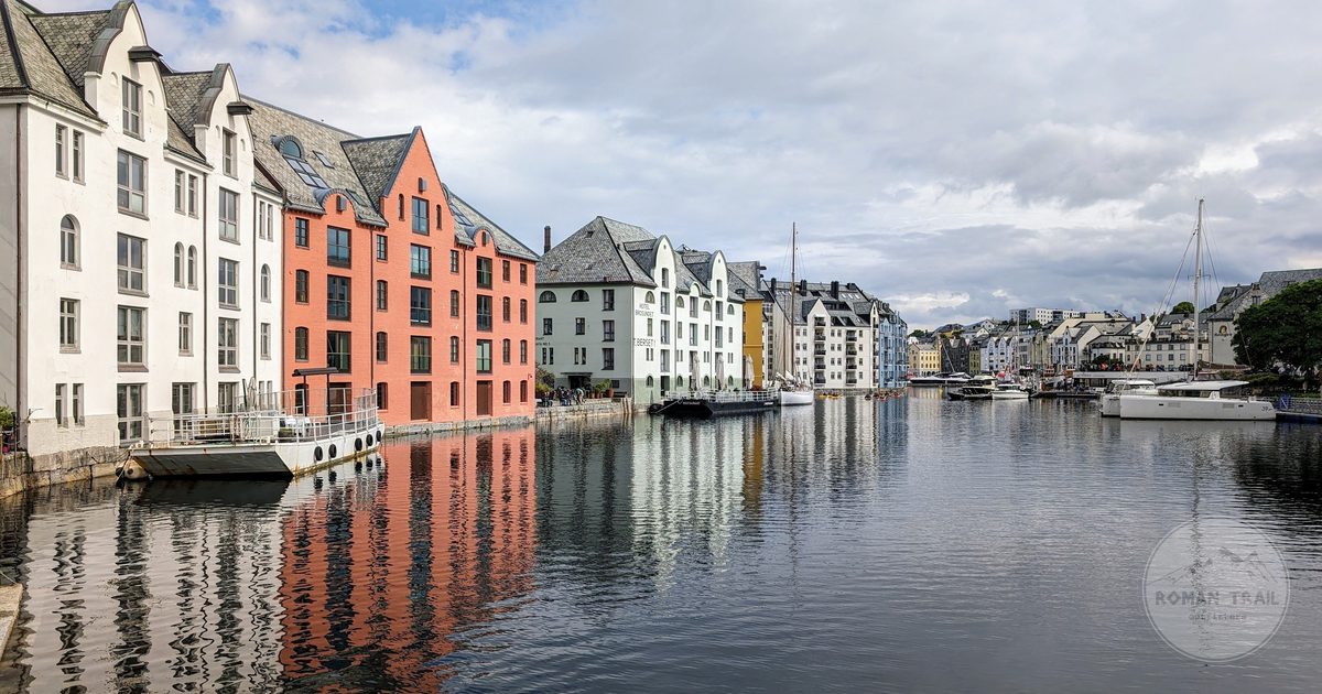 Colourful waterfront houses reflected in still water at Alesund, Norway
