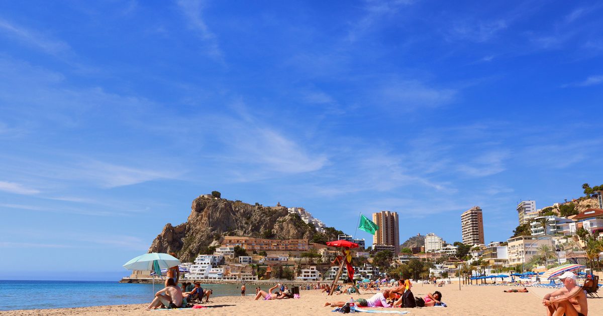 A beach at Alicante with the city behind under clear skies, Spain