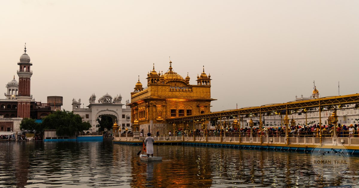 The Golden Temple lit in the evening with Sikh architecture around it, Amritsar packing list for women by Roman Trail Outfitters